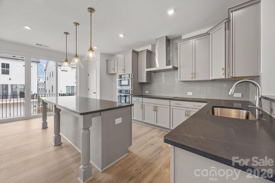 Welcome to The River District—a true master-planned community where lifestyle and location come together beautifully.

This beautifully appointed Landon three-story townhome offers a thoughtfully designed layout with a first-floor guest bedroom and full bath—perfect for visitors, multigenerational living, or a private home office.

The second level showcases a gourmet kitchen featuring quartz countertops, a built-in oven and microwave, electric cooktop, and soft-close cabinetry. The open-concept dining and living areas create an inviting space ideal for entertaining, while sliding glass doors lead to your private balcony—perfect for relaxing or enjoying your morning coffee.

Upstairs, you’ll find two beautiful owner’s retreats, each offering a bright, airy bedroom and a spa-inspired bath for ultimate comfort and privacy. A conveniently located laundry area completes the upper level.

This home is filled with beautifully curated interior finishes, individually hand-selected by our professional design team, creating a cohesive and elevated aesthetic throughout.

Location is everything—and at The River District, you’re truly minutes from it all. Planned community amenities include a resort-style pool, clubhouse with fitness center, tennis and pickleball courts, parks, scenic trails, a working two-acre farm with an on-site farmer, and a riverfront amphitheater.

Experience vibrant, connected living in one of the area’s most exciting communities.