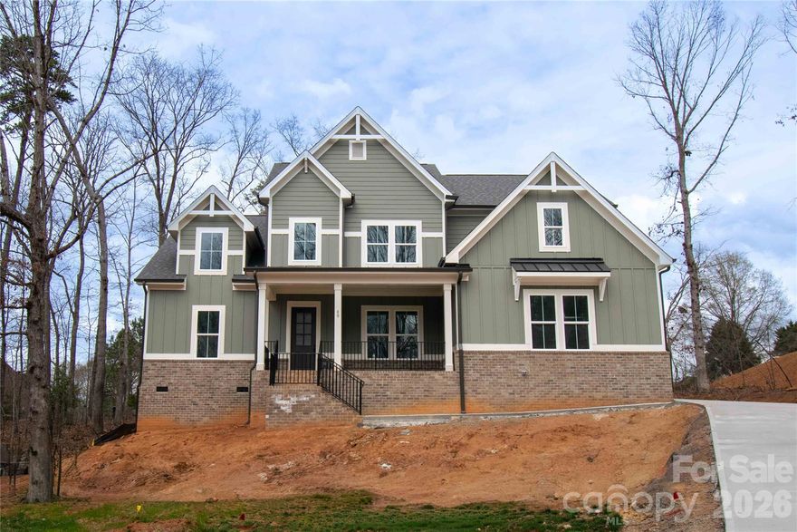 Discover timeless elegance in the Tiburon plan, offering 5 bedrooms, 4 baths, and curated luxury throughout. Enjoy 10' ceilings on the main level, site-finished hardwood flooring, and a chef’s kitchen complete with walk-in pantry. The open family room features a fireplace with built-ins, flowing seamlessly into the dining area for effortless entertaining. The main floor includes the primary suite plus a guest suite with a full bath—ideal for visitors or extended family living. Upstairs, you’ll find additional bedrooms with walk-in closets, including a private suite. A covered porch overlooking wooded views completes this thoughtfully designed home, blending comfort and sophistication at every turn.  Additional disclosures regarding utilities, HOA details, and construction timelines are available—please ask agent for more information.