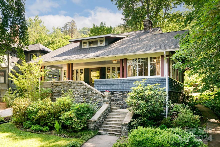 Located in the Heart of Asheville’s Grove Park neighborhood on the original trolly car line, you will find a contributing historic mountain Lodge of extraordinary magic; restored yet honored! This classic sits high above the road on a pastoral acre private-level yard with mature native plantings and the sounds of a creek. Two local mountain stone fireplaces, coffered ceilings, polished hardwoods, a library designed by Benbow & Assoc. & a stunning kitchen by Prock Custom Crafters. This cherished Lodge is offered for the first time in decades. A contributing structure in 'The National Historic District of Proximity Park', this example of an 'Arts & Crafts Shingled Style' will leave you breathless! Leave the front porch and walk on sidewalks to the City's Grove Park/Charlotte St. Park. Then meander on Charlotte Street to the finest bakeries, a wine merchant & a renowned butcher, a yoga studio & fine dining all on the cusp of Downtown Asheville, the 'Paris of the South.'