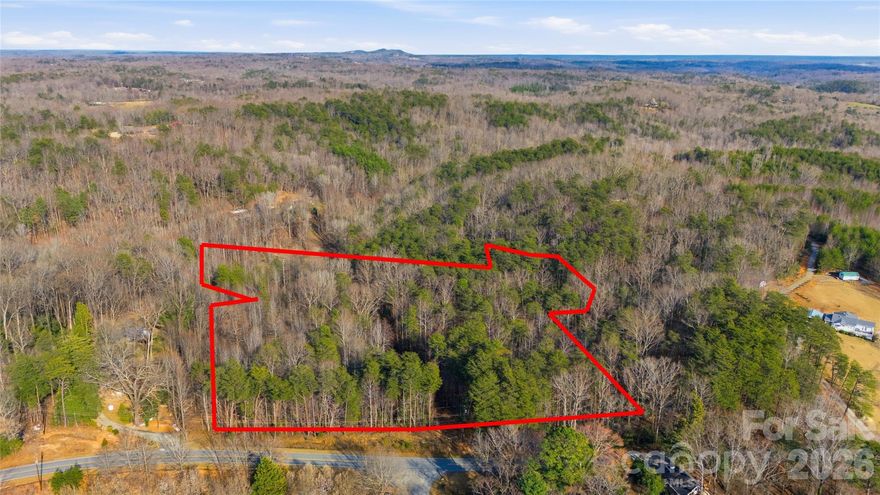 Rare opportunity to own 14.5 acres of unrestricted wooded land in the foothills in Tryon, NC —perfect for a private homesite, mountain retreat, or homestead.

Located on Hooker Road near the charming towns of Tryon, Landrum, and Columbus, this beautiful tract offers both privacy and convenience in one of the most desirable areas of the Carolina foothills. Whether you are looking to build a custom home, create a peaceful getaway, or invest in land with long-term potential, this property offers the flexibility and space to bring your vision to life.

The parcel features approximately 600 feet of road frontage on Hooker Road, providing excellent access and multiple potential building locations. The property is fully wooded, offering natural privacy, mature trees, and a peaceful setting filled with wildlife and natural beauty. With over fourteen acres to explore, there is plenty of room for trails, gardens, recreational space, or a secluded homesite tucked into the landscape.

One of the standout features of this property is that it is unrestricted, giving buyers the freedom to use the land without HOA regulations or restrictive covenants. This flexibility makes the property ideal for a variety of possibilities including a custom home, mountain retreat, small farm, or property with homestead potential.

Conveniently located just minutes from the restaurants, shops, and small-town charm of downtown Tryon, the property also offers easy access to Landrum and Columbus, with Spartanburg and Asheville within comfortable driving distance. Enjoy the peaceful setting of the Carolina foothills while still being close to everyday conveniences.

Large tracts of unrestricted land in this area are becoming increasingly difficult to find, making this a wonderful opportunity for buyers seeking privacy, natural beauty, and future potential.