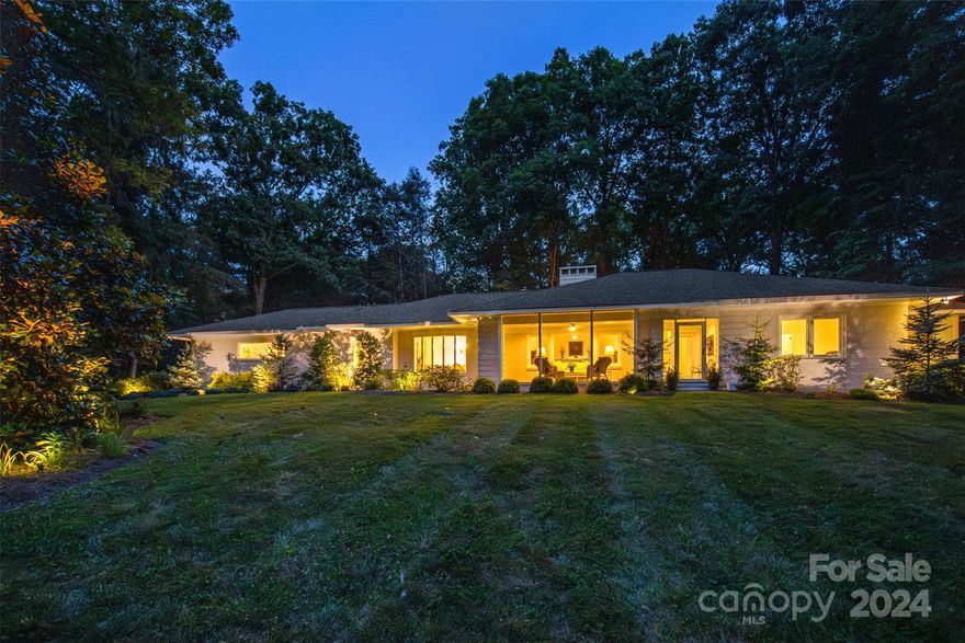 This Mid-Century-Made-Modern Biltmore Forest home on a gorgeous corner lot in Biltmore Forest, solidly built in 1954, was completely transformed in 2021 to reflect modern times.  New kitchen, new bathrooms, new HVAC, updated plumbing including on-demand water heater, updated electrical including new panel, fine interior finishes, and a new roof.  Guest suite with its own kitchenette is a perfect haven.  Generous placement of exterior lighting accents remarkable landscaping including Japanese maples, rhododendrons, hydrangeas and perennials.  The rolling front yard features an eye-catching magnolia dating back to the origin of the home as well as newly-created green space and extensive accent trees that fill the perimeter of the property with blossoms and color throughout the seasons.  Outdoor spaces for entertaining add even more delight to this home:  large screened porch overlooking the rolling front lawn and stamped concrete terrace among the perennial gardens in the back yard.