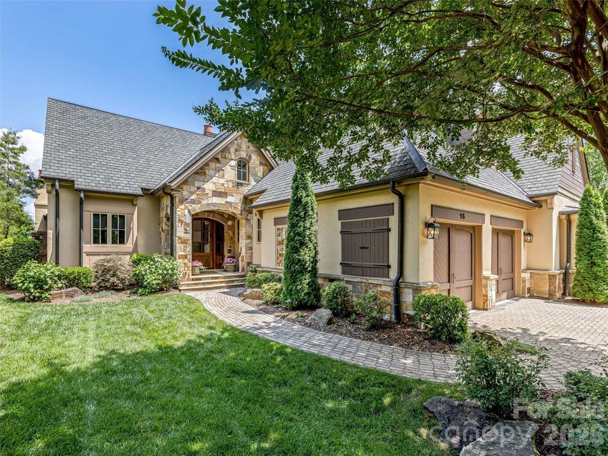 Nestled at the end of a quiet cul-de-sac within the prestigious gates of The Cliffs at Walnut Cove, this impeccably maintained townhome offers a refined mountain retreat where luxury meets a secluded, low-maintenance lifestyle. The main level is defined by an airy, open-concept floor plan characterized by soaring vaulted ceilings, dramatic timber trusses, and a floor-to-ceiling stone fireplace that creates a warm, inviting centerpiece for the great room. The gourmet kitchen is designed for the culinary enthusiast, featuring premium stainless appliances, a large center island for gathering, and a seamless flow into the dining area. For those seeking the ease of single-level living, the primary suite is conveniently located on the main floor, offering a spacious sanctuary with a spa-inspired ensuite bath and a generous walk-in closet.

The home’s design beautifully integrates indoor and outdoor living. Glass doors open to a wide balcony and an adjacent screened porch, where a second stone fireplace and rustic wood-planked ceiling provide the perfect setting to enjoy the mountain air in any season. On the lower level, the architecture is highlighted by massive masonry arches that frame views of the lush, manicured landscape.

Designed for effortless hosting, the lower level functions as a spacious secondary retreat, offering a large family room and wet bar with a generous footprint tailored for a customized entertainment experience. This level also includes two well-appointed ensuite guest rooms and a flexible bonus room. This versatile space can easily adapt to a home office, fitness studio, or hobby room depending on your needs.

Life at The Cliffs at Walnut Cove offers access to a world-class lifestyle anchored by an 18,000-square-foot wellness center with indoor and outdoor pools, tennis courts, and a luxury spa. The community is home to a renowned Jack Nicklaus Signature golf course and the award-winning Tavern clubhouse, which serves as a hub for fine dining and social connection. Bordering the Pisgah National Forest and located just moments from the Blue Ridge Parkway and the vibrant culture of Asheville, this home offers a rare combination of serene mountain living and convenient access to the region’s best recreational and cultural amenities.