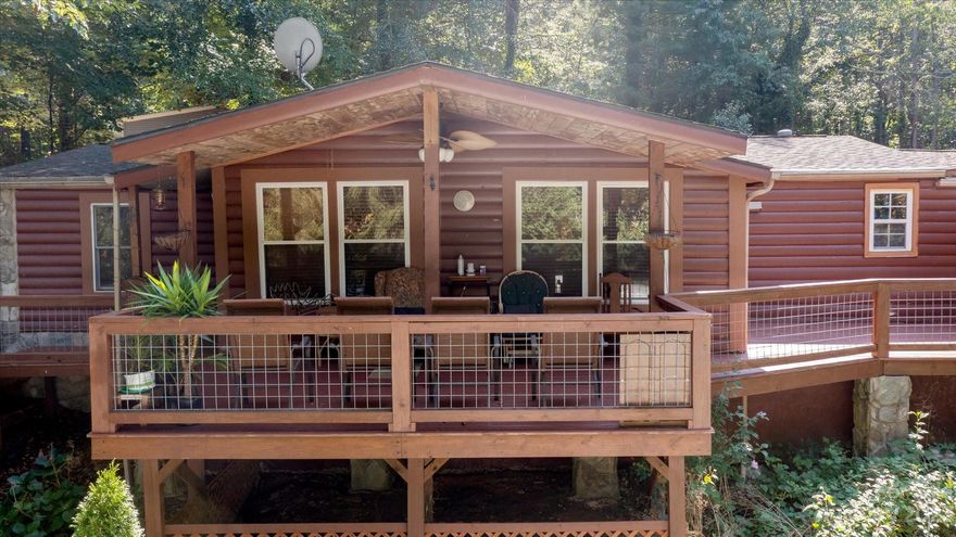 This charming property offers a peaceful retreat in the coveted Fairview area. Situated on nearly half an acre, this location provides a perfect blend of seclusion and accessibility. The cozy log-sided exterior and inviting covered front porch welcome you to the spacious interior, featuring 2 bedrooms and 2 bonus rooms. The large fenced back yard offers an art studio/workshop equipped with electricity and a relaxing gazebo with koi pond. A large wrap-around deck provides outdoor entertaining amidst nature's beauty. RV parking accommodates adventure seekers while high-speed internet provides connectivity. The large detached garage and two covered carports provide ample parking and storage. With it's harmonious blend of natural surroundings and functional features, this property presents an exceptional opportunity to embrace a balanced lifestyle in a great location. With the close proximity to Asheville, Hendersonville and all essential amenities, you can enjoy the best of both worlds!