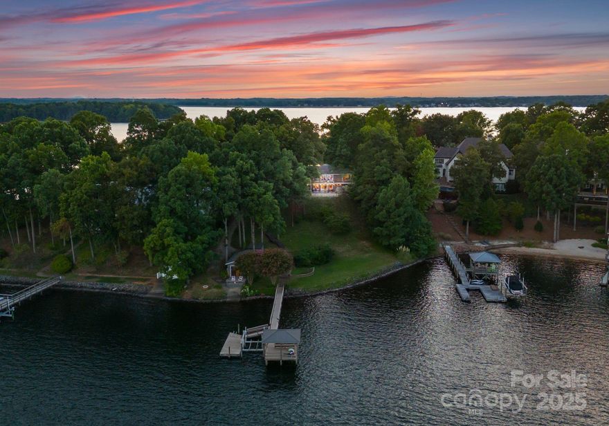 Crown Jewel Of Lake Norman! BREATHTAKING  VIEWS FOR THREE MILES! Cherished waterfront cottage on the pinnacle of Belle Isle. The most sought after address on Lake Norman. Nestled on a private cul-de-sac.Thoughtfully maintained and full of charm. A peaceful retreat with stunning year round deep water lake views and rooms to relax or entertain. Almost an acre lot and 200 feet of pristine shoreline. Oversized laundry room/drop zone. Back staircase to an upstairs bonus/flex space that could easily be an office or home gym. A quintessential grandfathered one bedroom/bath, boat house with kitchen and loft. Beautifully landscaped patios, mature perennial gardens and multiple sitting areas. Expansive waterfront from both the front and back of the house. Over 3700 square foot Cottage/Cape Cod home. Daylight walk out basement, with fireplace, custom built in bookcases, updated bath and lakeside bedroom. Decks, patios on both levels. Outdoor fireplace for cozy evenings lakeside. Outdoor screened in sleeping porch for lazy summers--- or watching football. The potential for this property are boundless!
We can provide preliminary plans and drawings for the property if someone wishes to change the property AND MAKE IT THEIR OWN! Live in it for a while and make changes gradually. The possibilities are infinite.