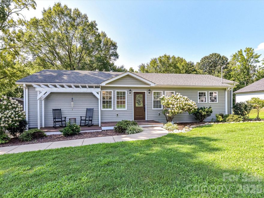 Discover this beautiful, hard to find, half acre ranch home on a peaceful street, minutes from I-85 in Kannapolis. Fully updated in 2017, this open-concept charmer boasts 3 bedrooms, 2 baths with a 18x20 detached garage & a large walkable crawlspace giving you tons of room for storage or hobbies! Enjoy granite countertops, custom cabinets, stainless appliances, and dimmable recessed lighting throughout. The primary suite features a stylish barn door, a spa-like tiled shower with dual heads, double vanity, and walk-in closet with barn door. The large laundry room offers ample storage and direct access to a spacious deck overlooking the private backyard—ideal for gatherings. New HVAC, Front door, and waterproofed crawlspace.