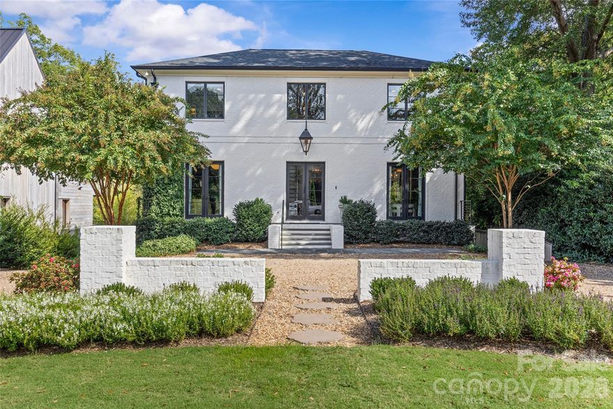 Stunning custom-built residence in desirable Myers Park! Completed in 2020 by Joyce Building Co, this exceptional 5BR, 6.5BA home offers nearly 6,000 sq/ft of refined living space across 3 levels. Situated on an exceptional 1.49-acre lot just around the corner from Freedom Park and Sugar Creek Greenway, the light-filled, open floor plan boasts soaring ceilings, designer lighting, custom millwork, and gorgeous white oak hardwoods throughout. The chef’s kitchen features custom cabinetry, quartzite countertops, Thermador appliances, expansive island, walk-in pantry and bar! The adjacent breakfast area and family room, with exposed beams and cast stone fireplace, flow seamlessly to a covered terrace with fireplace, heaters, and views of the lush backyard & pool. Upstairs find the luxurious primary suite with dual walk-in closets and spa-like bath, along with four spacious secondary bedrooms, all with custom closets and en-suite baths. The lower level offers a media room, exercise room with sauna and full bath, and a den opening to a covered patio with built-in grilling station, which extends to the saltwater pool/hot tub! With a 3-car garage, circular drive, and beautifully landscaped grounds, this home blends timeless design, modern amenities, and exceptional outdoor living in one of Charlotte’s most sought-after neighborhoods.