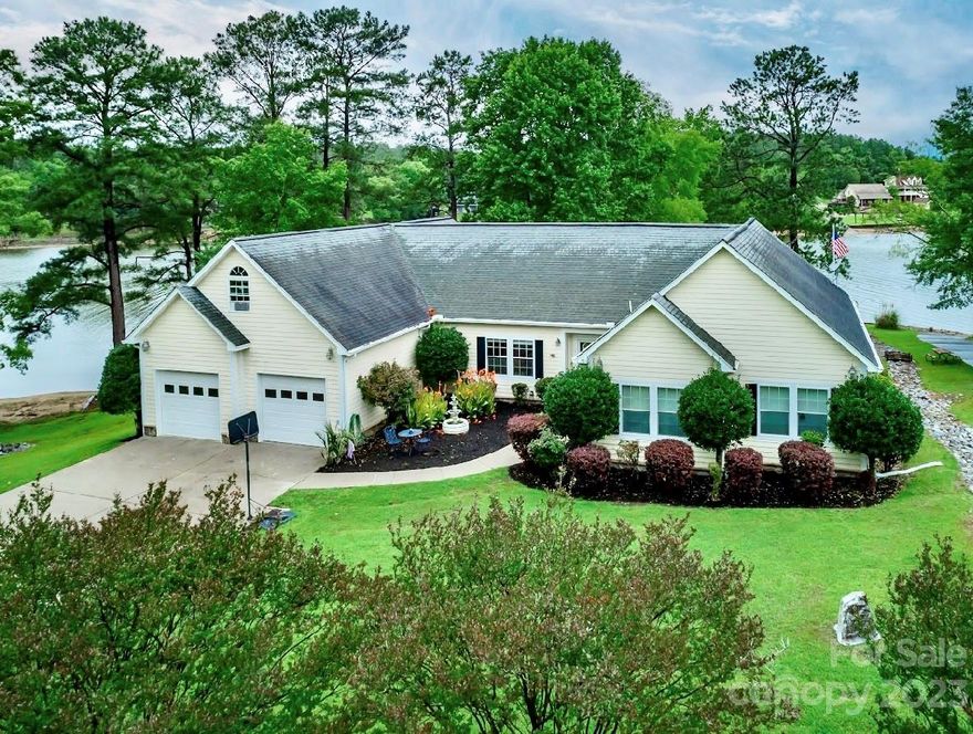 What a beauty! An absolutely perfect manicured lot is available now on one of the nicest streets on Lake Wateree. The home boasts beautiful lake views all across the water side via over-sized wall to wall windows. The spacious split floor plan is centered around a huge open living area featuring hardwood floors, recessed lighting, a wet bar, large built ins and a gas log fireplace. In addition to the approx. 3000 square feet of living space, the home sits on a full unfinished basement. The two car garage also has a FROG that is unfinished. Lots of potential and lots of future space to develop how you like. The lot is beautifully landscaped with a retaining wall, a swim area, and a very nice stationary dock with floater, water slide and pontoon boat lift. This is the one you've been waiting for!