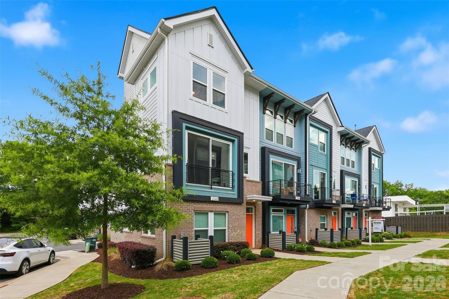 Incredible move-in ready, single-owner, end-unit townhome within walking distance to everything NoDa has to offer! Enjoy super easy parking with your first-floor, two-car tandem attached garage.

The main floor features a bright, open kitchen equipped with a generous island, updated lighting, and tons of cabinet space. It flows seamlessly into a great dining area and a spacious living room. The sellers installed custom built-ins with an electric fireplace for extra storage, plus automated shades make it effortless to adjust for privacy or natural light. A convenient half bath finishes off this main living level.

Up on the third floor, a smart split-bedroom layout gives everyone plenty of privacy. The primary suite features a double vanity and a sizeable glass-door shower, while the guest bedroom includes a walk-in closet and its own full hallway bath with a tub.

Working from home is a breeze thanks to the top-floor loft that is perfect for a quiet office complete with its own private powder room. When it's time to clock out, step onto the expansive rooftop terrace to unwind and take in the neighborhood views.

HOA fee covers landscaping, water, sewer, trash/recycling pick up, termite bond and exterior maintenance. With no rental restrictions, this home is an amazing, turn-key opportunity for investors, as well! Washer/dryer and refrigerator convey!