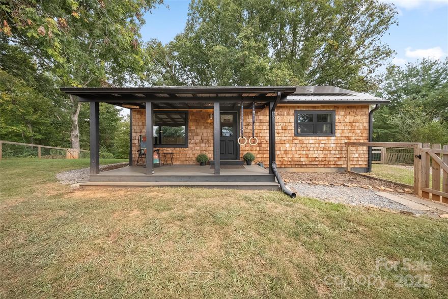 ***see video***This delightful 1950s bungalow offers the perfect balance of privacy, convenience, & character. Located just minutes from the shops, cafés, & small-town charm of downtown Weaverville, yet far enough away to feel tucked into your own retreat, this home is a true gem.

Step inside to discover main-level living at its best. An easy entry & ample parking make day-to-day life simple, while the open, bright, & airy floor plan invites you to settle in & stay awhile. The interior layout creates a natural flow, making it just as comfortable for entertaining friends as it is for enjoying a quiet evening at home. The newly added covered front porch extends your living space outdoors, offering the perfect spot for morning coffee, evening relaxation, or greeting guests. A level, fully fenced yard provides privacy & peace of mind—ideal for pets, gardening, or play. Outdoor enthusiasts will appreciate the opportunity to further enhance the yard into a personalized oasis. Sustainability & efficiency shine here with the addition of solar panels, keeping energy costs low while supporting an eco-friendly lifestyle. This thoughtful upgrade makes the home as practical as it is charming. Whether you’re searching for your first home, a cozy downsizing opportunity, or a private retreat close to Asheville’s vibrant mountain lifestyle, this bungalow checks all the boxes. Its combination of charm, convenience, and potential makes it a rare find in the Weaverville market. Don’t miss your chance to make this inviting home yours and enjoy everything this welcoming community has to offer.