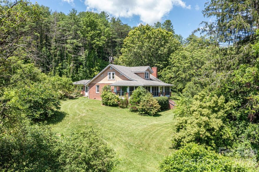 Welcome to the “Mini Farm on McLean” – a rare and scenic 15-acre homestead less than 5 miles from downtown Weaverville. At the center sits a character-filled 1934 farmhouse offering main-level living, 4 bedrooms, and flexible spaces just waiting for your personal touch. Enjoy mornings and quiet evenings on the all-seasons front porch, surrounded by flowering plants and picturesque views. The property includes a powered detached workshop—ideal for artists, makers, or those seeking a creative escape. Once a working farm, there is a classic barn, a meandering creek, and untouched acres to explore. With potential additional home-sites and beautiful mountain views, the possibilities for the next chapter are wide open. Lovingly held in the same family for nearly a century, it’s now ready to be passed on and re-imagined by its next steward. Whether you’re dreaming of a hobby farm, family compound, or simply a peaceful place to call home, this one-of-a-kind property is a rare opportunity.