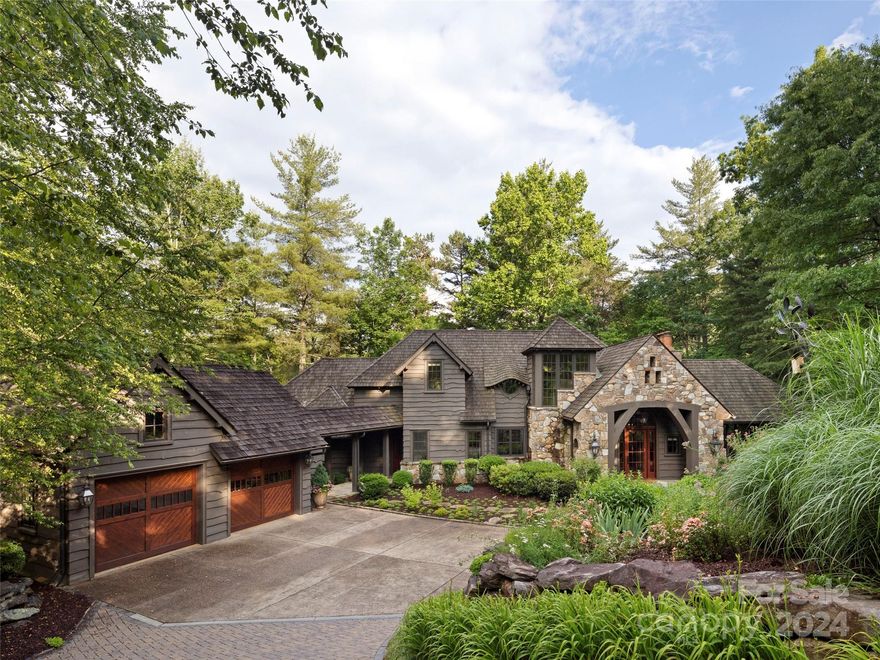 Tucked into a quiet, wooded location in the gated community of The Cliffs at Walnut Cove lies a surprising jewel. Perfectly proportioned with thoughtful finishes, this home offers a respite from the outside world. Extensive perennial gardens, natural edge cedar siding, a ‘pondless’ waterfall, geothermal heating, and solid post and beam design create the setting. Inside you will find elegant full masonry fireplaces, paneled and beamed ceilings, gorgeous first growth Heart Pine floors, an inviting screened porch, and stunning kitchen with a sprawling granite island, ideal for any cook. Special highlights include a fabulous hidden walk-in kitchen pantry, a cozy window seat for reading in the loft craft room, a built-in Jefferson bed nook plus hidden wine room on the terrace level, and a main level, centrally located laundry room and mud room with charming Dutch doors, open shelves and built-ins. Here the fusion of nature and craftsmanship creates a sanctuary that transcends the ordinary