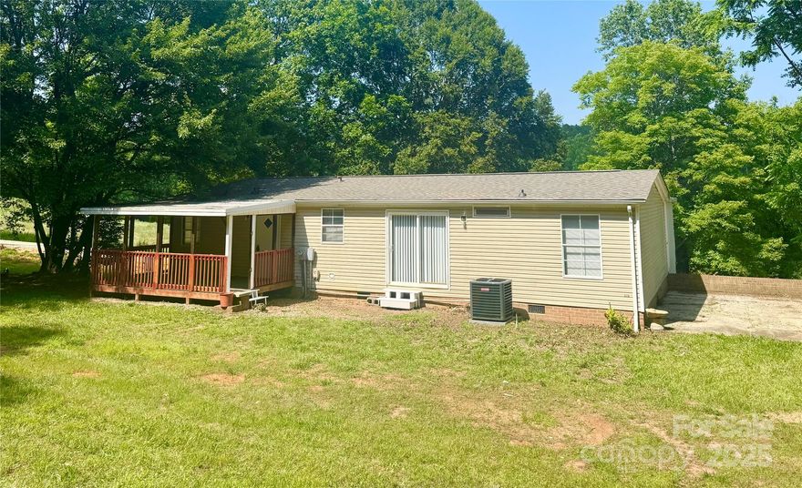 Charming 3-bedroom, 2-bathroom home perfect for those seeking comfort and style. The kitchen has been beautifully remodeled with brand-new cabinets and sleek granite countertops, offering both elegance and functionality. Freshly painted interior and brand-new vinyl flooring in the main living areas create a warm and modern feel throughout. New Roof and HVAC system. 

Enjoy peaceful afternoons on the front porch — the perfect spot to relax or gather with friends while taking in the serene view. The back porch offers additional outdoor living space for entertaining or unwinding. Featuring an open layout and complete privacy, this home is designed for modern living.

Surrounded by mature trees, the property offers a refreshing natural environment and cool shade year-round. Don’t miss out on this opportunity to own a home that truly has it all!