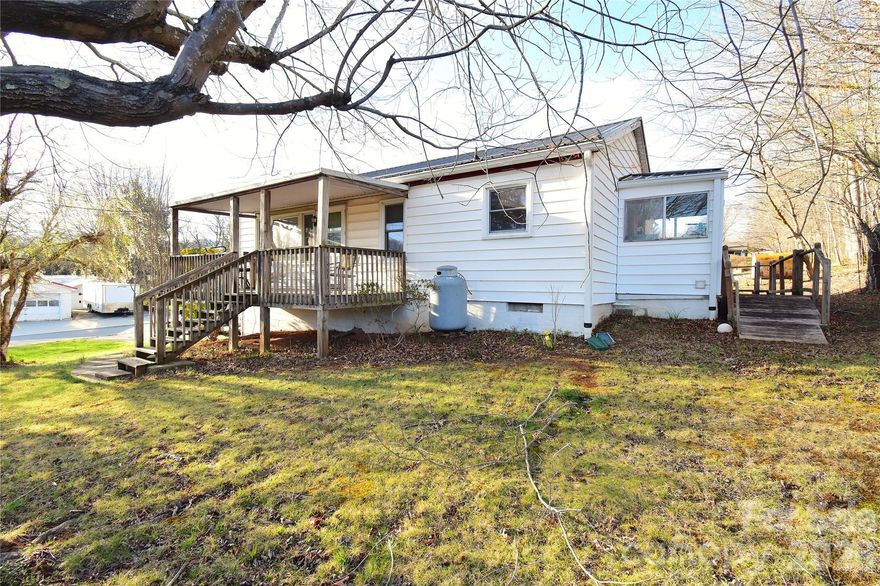 Charming Home In Candler Offering A Perfect Blend Of Classic Character With Some Modern Updates!  2 Bedrooms With Wood Floors, 1 Recently Remodeled Full Bath, 940 SqFt, Large Living Room With Wood Floors & Ceiling Fan & Picture Window, Oversized Eat-In Kitchen With Plenty Of Cabinet & Counter Space,  Durable Metal Roof – Ensuring Long Term Protection, Spacious Full Basement With 1-Car Garage - Offering Ample Storage Space Or Workshop/Recreation Space, Carport, Large Covered Front Deck, Large Landscaped Lot, Newer Heat Pump & Water Heater & Gutters, Just minutes From Downtown Asheville – Grocery Stores – Restaurants – I40 – The Parkway – And More!