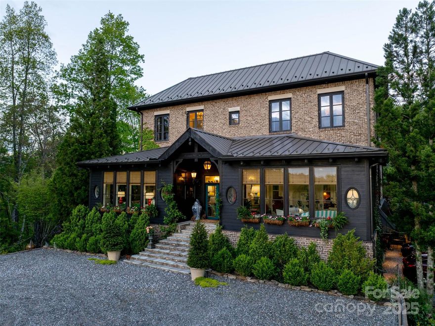 Carlin Manor is an exquisite estate, 17+ acres w/ sweeping, long-range views of Wolf Lake. Curated elegance, w/ lush gardens, sculpted landscaping, & timeless architecture. Designed for grand entertaining & quiet repose, featuring multiple sitting rooms & sunrooms, w/ breathtaking vistas. Rich marble, tile, & hardwood flooring throughout the home, complement the refined aesthetic at every turn. A chef’s kitchen of exceptional quality, a Wolf gas range, & generous center island ideal for culinary artistry & casual gatherings. A grand dining room for memorable occasions, spa-like baths w/ clawfoot tubs & marble vanities evoke timeless European charm. French doors lead to an outdoor terrace, a pergola & dedicated al fresco dining space suited for evening soirees. Every detail thoughtfully considered from the distinctive bark and brick exterior to the bespoke lighting, artisanal hardware, and inviting fireplaces that encourage conversation and quiet reflection throughout the home.