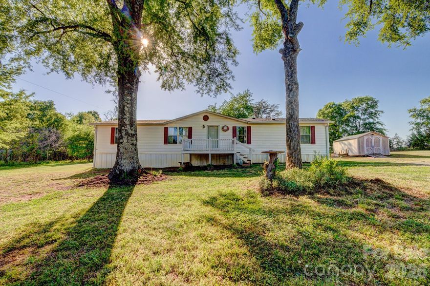 This 4-bedroom home is situated on 1.24 acres in rural Cleveland County. The long driveway and spacious yard provide additional privacy. Inside, you'll find a living room, a den, a kitchen, and a dining room. The layout features a split-bedroom design, with the primary bedroom separated from the other bedrooms. Additionally, the Goodman heat pump was manufactured in May 2022.