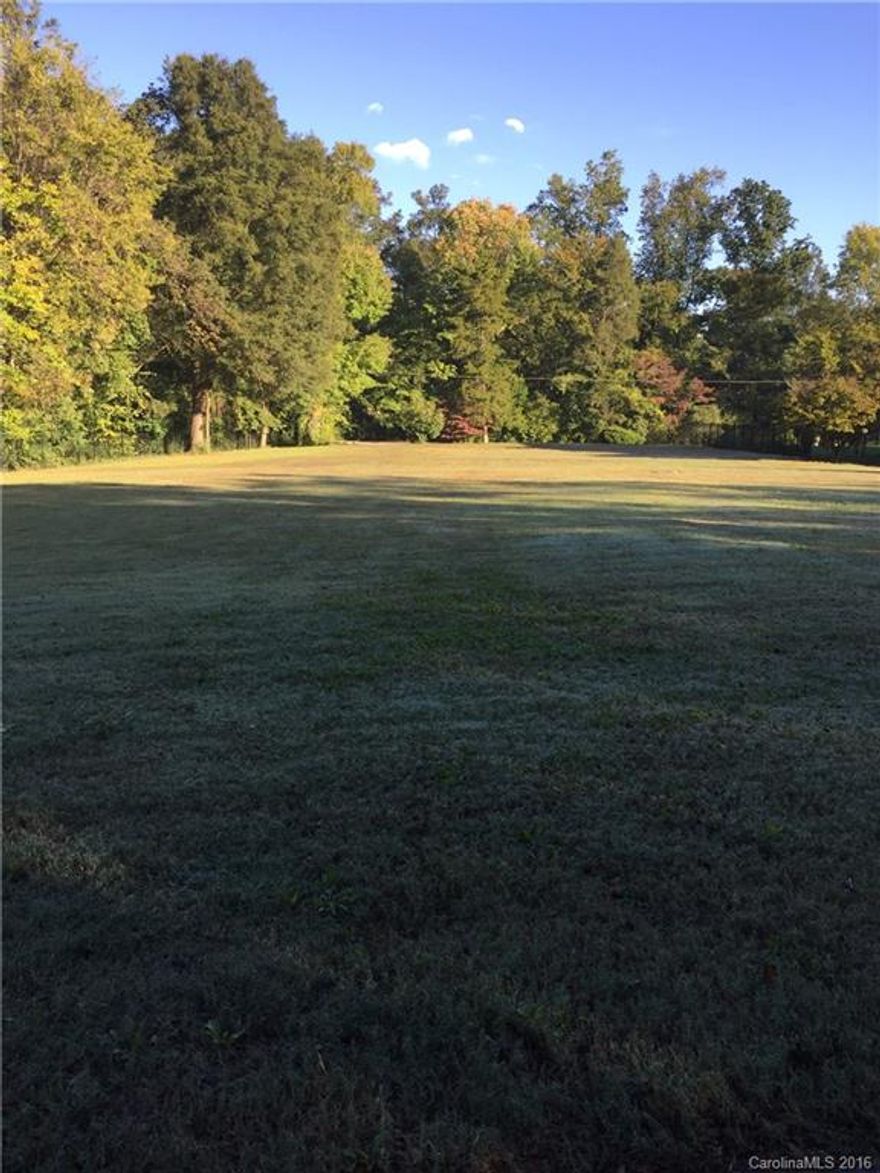 Just reduced over $100,000 to reflect seller's motivation.  1.1 acres lot backing to Myers Park Country Club golf course.  50 foot swim buffer at rear of property.  Seller is original owner and will finalize sub dividing property for buyer.  Minimum square footage for home to be built is 3000 square feet.
