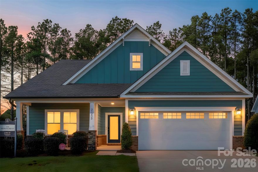 Welcome to 21232 Sanctuary Drive, a never-before lived in, former model home located in the award winning Edgewater community. This home is filled with high end upgrades and thoughtfully designed features, offering low maintenance, age-in-place living with true forever home appeal.

The chef’s kitchen is the heart of the home and features a built in coffee bar, pantry, oversized island with bar seating, gas cooktop, brand new appliances, breakfast nook, and abundant storage space. Just off the kitchen are a formal dining area and beautiful living area, creating an ideal layout for both everyday living and hosting.

The spacious primary suite is located on the main level and features a tray ceiling, elegant column details, and a sun-soaked attached sitting room. The ensuite bathroom offers a step in shower, large walk in closet, and generous vanity space. From the primary bedroom, step directly into your screened-in porch overlooking a wooded & private tree-save area with no homes behind you.

Also on the main floor are your second bedroom and bathroom, laundry room, and a two car garage. The home is filled with natural light throughout and offers a seamless, functional layout.

Upstairs, you will find a large multi use loft area with an oversized storage closet, along with an additional bedroom and a full Jack and Jill bathroom, perfect for guests or flexible living needs.

Edgewater is a highly sought after, award-winning waterfront community known for its resort style amenities and close knit atmosphere. HOA dues are only $195 per month and include lawn maintenance along with access to a wide range of amenities. Residents enjoy a nationally-ranked 18-hole golf course, marina and boat storage on the Catawba River, fishing ponds, lakeside pavilion with a kayak launch, fire pits and games, community center with pool, professional tennis and pickleball courts, walking trails, Top Tracer driving range, putting green, and an on-site restaurant.The community also staffs a full time activities director with an active social calendar, featuring events such as bunco, wine tastings, and community dinners. Edgewater offers a unique blend of lakeside tranquility and modern convenience. Limited opportunity to own in an exclusive area of The Cottages with direct access to a passive park area. Located just outside of Charlotte, this master-planned community provides easy access to shopping, dining, and top-tier entertainment while allowing residents to escape the hustle and bustle of city life. With nearby access to Highway 521 and I-77, commuting to Charlotte or Rock Hill is seamless.