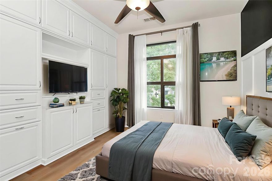 GREAT SOUTH END LOCATION! This gorgeous MOVE-IN READY open-concept condominium boasting soaring 10’ ceilings w/elegant crown molding has been thoughtfully & recently upgraded for style & function & features board-and-batten accent walls that add charm & architectural interest throughout. Custom “Closets by Design” storage includes a maximized master closet, redesigned entry closet, & built-in custom storage solutions. A wet bar & built-in media center enhance convenience & modern appeal. The kitchen has coffered ceiling, above-counter composite farm sink, waterfall faucet, ornate tile backsplash, & granite countertops on both the perimeter & island w/updated appliances including Refrigerator. The master bath features quartz countertops & designer finishes. Located in one of Charlotte’s most sought-after communities w/private parking lot & Semi-private balcony. Unbeatable location w/shopping, dining, coffee shops, & parks within walking distance. Steps from the light rail for quick access to Uptown & South End.