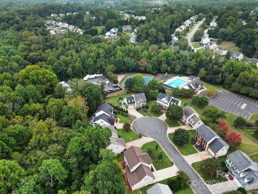 Prepare to fall in love with this meticulously maintained & updated home. Nestled in a small culdesac with no neighbors behind, you'll enjoy privacy, the walking trail, creek & peaceful sounds of nature. The expansive decking & large backyard is perfect for entertaining. Roast marshmallows around the firepit while taking in a movie under the stars! Main level features gleaming bamboo floors, a large office/french doors, formal dining room, breakfast area/butlers pantry, living room/gas fireplace, half bath, laundry room & 2nd living area/man cave. Updated kitchen with gas range, cream colored cabinets, quartz counters, tile backsplash & new lighting. Upper level has 4 bedrooms & 2 full bathrooms. Gorgeous Master Suite with large custom dual head shower, bench & walk-in closet.  Detailed update list available: Roof, HVAC, Windows, H20 heater, plumbing supply lines, Kitchen, Deck, Master Bath. Ample storage!. Clubhouse, pool, playground, & pickleball just steps away. Fort Mill Schools!!