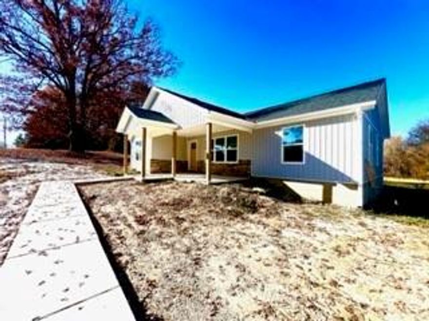 New construction!!  This is a very user friendly and popular floor plan, covered front porch with a rear patio. Feature grey vertical siding, granite countertops, neutral colors throughout. Even comes with a higher end refrigerator (which is rare for a new home) Parking pad is concrete but driveway is gravel, Low county taxes but convenient to town. Large almost 3/4 of an acre lot on well and septic.