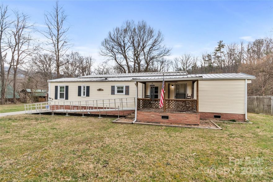 Welcome to your waterside retreat! With ±67' of frontage along Spring Creek, a designated NC Mountain Heritage trout water, enjoy fishing for brown, brook and rainbow trout, or simply lounge & be lulled by the peacefulness of the water. Inside you'll find a split bedroom plan, updated kitchen and full bath, along with vinyl plank flooring throughout. The recent installation of new vinyl windows offer extra insulation & efficiency. The property is less than a mile from downtown Hot Springs which is being rebuilt following Helene to be more vibrant than ever with its shops, restaurants, natural hot springs spa, and art galleries. This property is the perfect primary residence or second home getaway!