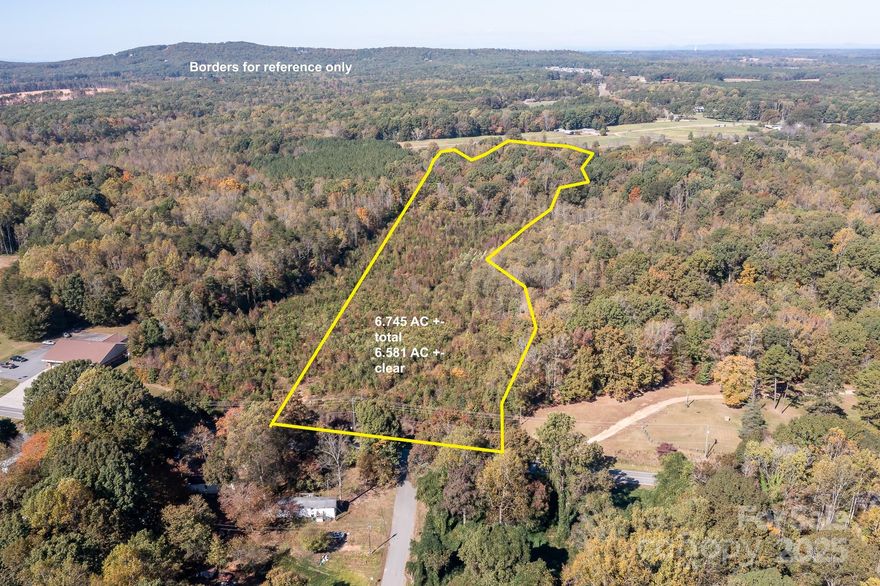 Spacious 6.5+ acre lot in a convenient Sherrills Ford location. Private, wooded setting offers peace and seclusion while remaining close to local amenities. Perfect opportunity to build your dream home or establish a private homestead. No perk test on file. Call agent for more information.
