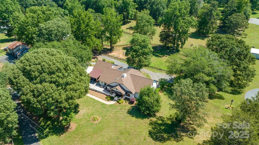 Who knew such a place just 12 miles from Uptown and minutes to Mountain Island Lake and the airport existed? With all the convenience of being in Charlotte but the beauty of an almost 6-acre horse farm, this home is a slice of heaven. As this gorgeous, all brick farmhouse with basement home comes into view, you will be in awe of the splendor of the rolling hills, mature landscaping and horses in the pasture. Inside you will find spacious rooms, exquisite attention to detail, hardwoods throughout much of the home and a gorgeous sunroom overlooking the pastures. The finished basement is equally spacious, offering additional living space, a full bath and several multipurpose rooms. The barn includes 4 stalls, a tack room, 2 pastures and a riding ring. The detached, 1 bed/1 bath with kitchen guest house is currently being used as an Airbnb. Income approx.: $19k/yr. Also listed in MLS under residential, MLS #: 4145958. Please schedule an appt before coming down the private drive.