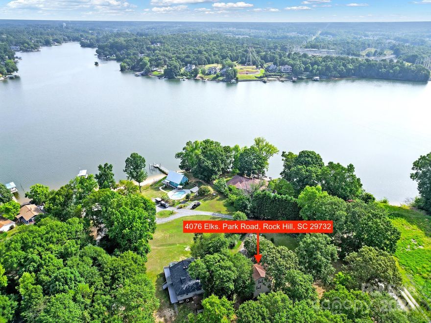 Amazing year round water view of Lake Wylie with no HOA! Pull in the gravel driveway to an oversized 2 car garage w/ plenty of room to work & park. Walk up the stairs on the side of the house & through the door to find a large open living room w/ beautiful, rare, red cherrywood wide plank flooring, french doors that open up to a 2nd story deck with a beautiful year-round water view of Lake Wylie. Brand new HVAC in 2024. Cozy kitchen w/ lots of solid wood cabinets for the storage, an oversized sink & tile countertops. The main floor bedroom has large closets & solid tongue & groove oak flooring. Upstairs you'll find a spacious loft bedroom w/ a half bath & nook that could be easily converted to a closet (By MLS definition, this bedroom fits all criteria of a bedroom, minus a closet.) The large 1 acre lot leaves room for many possibilities & the home has great bones & potential to make it your own! Very close to lake parks for lake access, restaurants, retail, schools, & I-77.