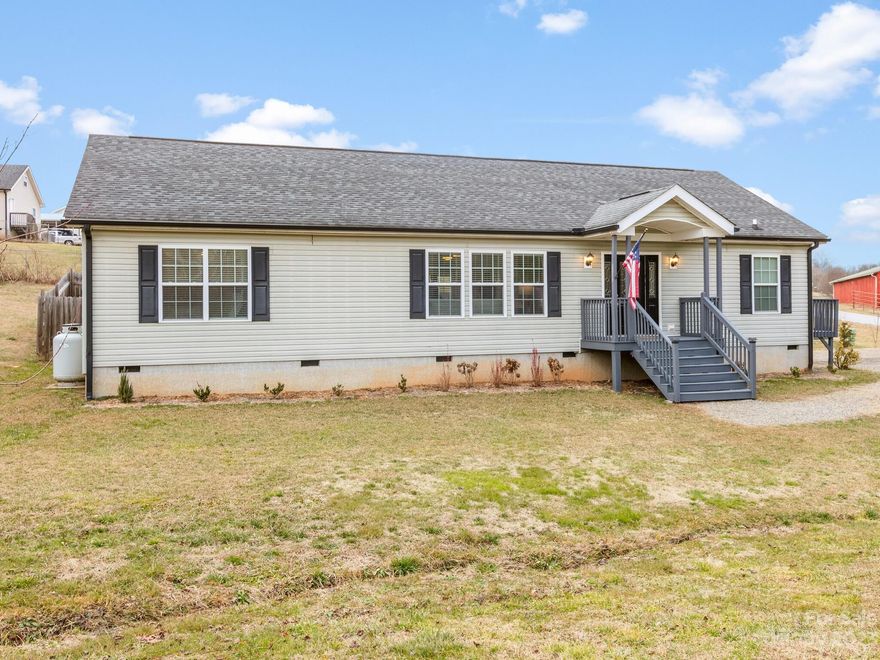 Great home located in Candler NC, approximately 20 minute drive to Asheville NC.  This home is in great condition and has much to offer.  The home has an open floor plan with split bedrooms.  There is a flex/bonus room that is currently used as a 3rd bedroom, but septic permit only calls for a two bedroom.  The primary suite is generous in size with a walk in closet.  The living room has a cozy gas log fire place.  There is also a large laundry room.  All of these interior features are on one level.  If you are into spending time outside you will not be disappointed.  There is a level yard equipped with fire pit, utility building and play set.  The front porch is covered and the rear of the house has a large deck for grilling and hanging out.  A section of the back yard is also fenced in.  If its storage that you are looking for you will love the attic in this house.  It is accessed by a fixed set of stairs and spans the entire length of the home with plywood flooring.