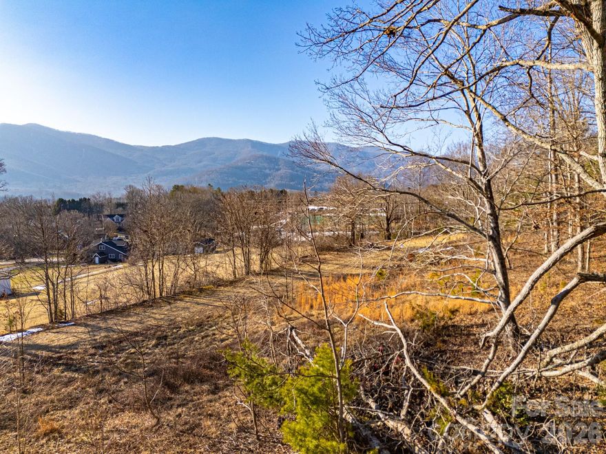 Rarely will you find land in Buncombe County this flat and build-ready without being in a subdivision. This .69-acre parcel offers nearly 100% usable space, making it exceptionally easy to visualize and design your future home without the challenges of steep grades. The property captures beautiful year-round light and frames unobstructed views of Buck Ridge and the Swannanoa Mountains — a pristine, undeveloped backdrop that adds privacy and serenity. Already partially cleared and ready for your plans, the property has no storm damage from Hurricane Helene and comes with a completed perk test for a septic system, saving you time and money in the building process. Whether you envision a full-time residence, mountain getaway, or investment build, this lot delivers the rare combination of easy buildability and breathtaking scenery. Located just minutes from downtown Black Mountain’s shops, restaurants, and trailheads and right around the corner from Lake Eden.