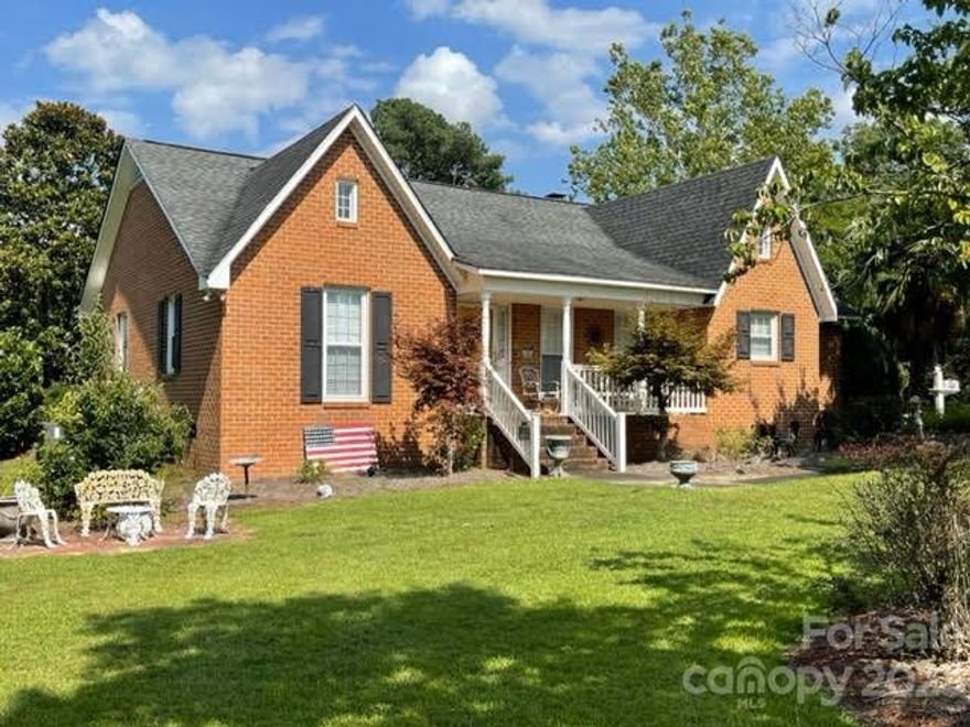 As soon as you turn into the driveway of this beautiful home, you will be amazed at all the love and work that has been put into the grounds.  It is ready to be revived to its original beauty.  There are so many special areas to enjoy around the yard as well as the front and back porches.  From the driveway, enter through the mudroom and continue to the kitchen and breakfast area, which features beautiful cabinets, granite countertops, and a pot rack. Large dining room and huge living room will accommodate lots of guests.  Bedrooms are all good size and have great closet space.  You will notice attention to detail throughout the house, including hardwood floors, laundry room sink, plantation shutters, and more.  There is a goldfish pond by the detached garage.  The back porch is a great place to relax and enjoy the beauty the grounds offer.  The property is on city water but also has a well for outside use. There is a workshop in the back of the garage, separate wall and door entrance.