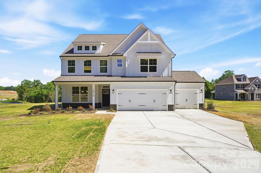 Tranquility plus convenience equals your new home in Mint Hill! This beautiful community features large homesites with easy interstate access. Homesite 55 features a 3-story Davidson plan with 4 bedrooms, 3 full baths, a 3-car garage, and more than 3,400 square feet of living space on a 1-acre lot. The main floor features a family room with an Allusion electric fireplace surrounded by a shiplap feature wall with wooden mantel. The designer kitchen has white cabinets with a contrasting-color island, quartz counters, a tile backsplash, and stainless appliances, including a range hood and electric cooktop. The kitchen is connected to the dining room with a butler pantry that has upper and lower white cabinets & quartz counters to match the kitchen decor. The main floor also has a guest bedroom, a full bath with a tiled, 4-ft shower, and mud room with a beadboard drop zone. The second level includes a loft, two secondary bedrooms, a full bath with tub/shower combo, and the primary suite with a tiled, luxury shower with bench seat & semi-frameless door. The third floor has a large bonus room with 375 square feet. Enjoy the outdoors on the rear covered porch or the paver patio with firepit & seating wall. Visit today and find out more!