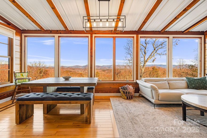 Two separate Historic log cabins from 1812 were reassembled in 1991 atop this 12+ acre mountaintop.  Mount Mitchell and Roan Mountain all the way in Tennessee are visible from the dining room.  Both cabins have high ceilings, amazing views, and up to date amenities.
The guest cabin has operated as an Airbnb.  Both cabins will come fully furnished, with the exception of a few items.
Both cabins share an elegant courtyard with hydrangeas, japanese maples, and flowers galore. A mini orchard sits below to supply you with peaches, blueberries, apples, pears and pecans.  
Next door on the same parcel a 1.5 acre home site that has been cleared for a 2800 sqft home.  Well and Septic permits exist and have already been approved by county.
This investment opportunity or mountain retreat is just over an hour from the CLT Airport, one hour to Asheville and 45 minutes to Lake Lure.  
If quiet serenity is what you’re looking for or what you want for your guests, this could be the one!