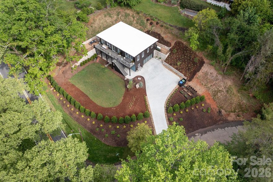 Located in the heart of North Asheville’s vibrant Lakeview Park, near AVL Country Club, this modern, recently built home offers the rare combination of in-town convenience and quiet comfort. With sweeping views of Beaver Lake and a nearby wildflower field, the home is filled with natural light thanks to floor-to-ceiling, south-facing windows and an open, thoughtful layout. Each bedroom features its own ensuite bath, and the spacious kitchen is perfect for cooking, gathering, and entertaining. Step outside to enjoy a sunny deck, a professionally landscaped yard, and a newly installed private, sound-mitigating fence that creates a more secluded outdoor setting, along with a private saltwater hot tub. Smart upgrades include wiring in place for an EV charger (with capacity for two), a whole-house generator, and energy-efficient design throughout. Just moments from walking trails, bird sanctuary, local dining, and North Asheville’s favorite amenities, this home blends modern style with easy everyday living in one of the city’s most loved neighborhoods. Priced below appraised value.