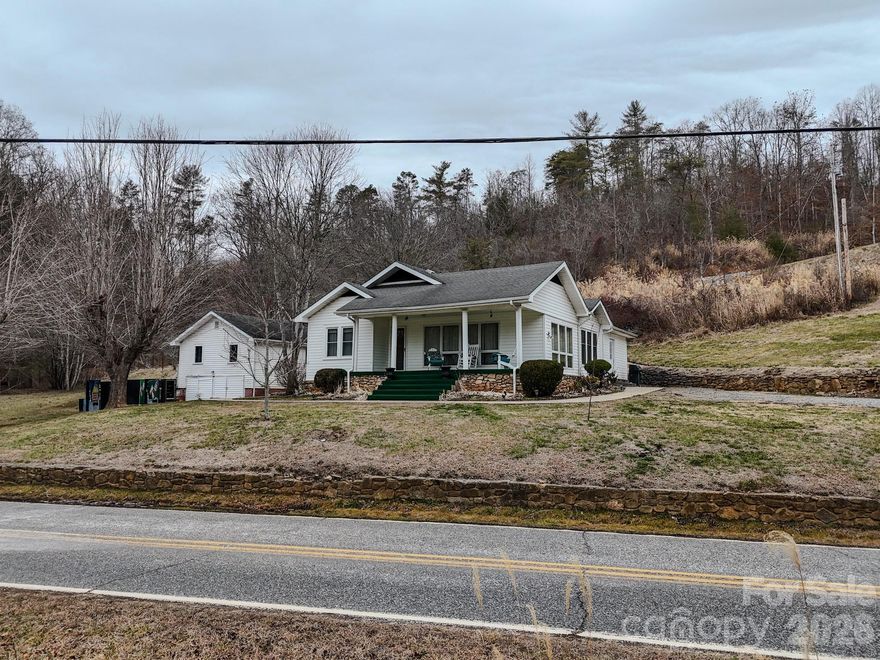 Tucked away on a peaceful one-acre homesite in Marshall, this three-bedroom home offers a relaxed mountain lifestyle with the convenience of being close to town. Designed for easy one-level living, the home features a spacious kitchen, warm wood floors, and multiple living areas including a living room, family room, and dedicated dining room—ideal for both everyday living and entertaining. A detached two-car garage provides ample space for vehicles, storage, or hobbies. With room to spread out and enjoy added privacy, this property is a wonderful fit for those seeking space and tranquility in Western North Carolina.