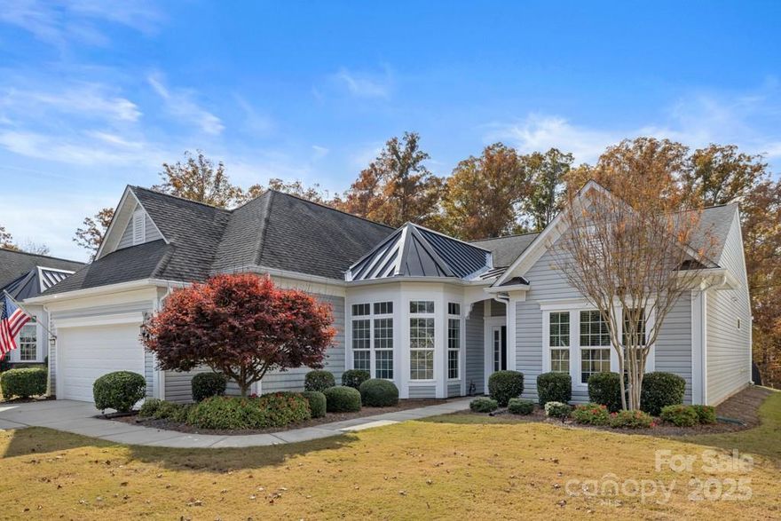 Exquisitely maintained Cumberland Hall on a private homesite with wooded views in Sun City Carolina Lakes. Built in 2015 and cared for by its original owner, this home blends timeless design with modern comfort. Enjoy wooded views from the sunroom and screened porch with sun shades. Exterior features include a fenced backyard, widened driveway, enlarged gutters with leaf guards, and a robotic lawn mower. The gourmet kitchen offers granite countertops, stainless steel appliances, double-door pantry, under-cabinet lighting, and cabinet roll-outs. Hardwood floors flow through main living areas complemented by crown molding and wainscoting. Laundry includes granite counters, cabinetry, and a sink. The primary suite has a tray ceiling and spa-like bath with frameless shower, dual vanity, and tile surround. Additional highlights: fireplace with blower, 2" faux wood blinds, irrigation system, and garage with workbench and attic storage. Residents enjoy resort-style amenities including two clubhouses, indoor/outdoor pools, fitness centers, tennis and pickleball courts, golf course, walking trails, and a full social calendar.