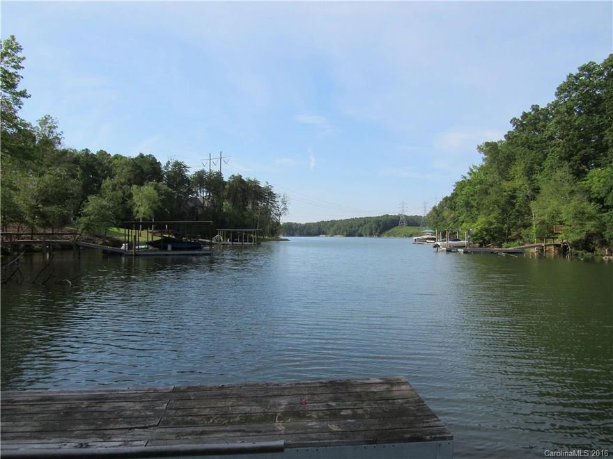 Build your dream home on an incredible waterfront lot! Just a short walk from the community pool, and located in the excellent Clover school district. Wooded lot offers plenty of privacy, and is on a cove opening to the Big Allison inlet of Lake Wylie. Perfect area for boating and watersports! Dock is in place, ready for you to enjoy while building your home. Convenient to Charlotte, Gastonia, and Rock Hill.