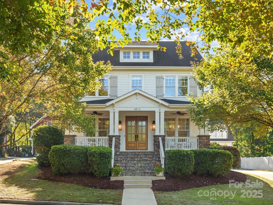 Nestled in the heart of Baxter Village, 4912 Kenbury Ct blends custom design with everyday functionality. This 5-bedroom, 3.5-bathroom home is on a pocket park for beautiful views from the front porch. Featuring hardwood floors & custom moulding, formal dining, office w/ large closet (or 5th bedroom), laundry w/ custom cabinetry & wine fridge. Updated kitchen includes marble backsplash, quartz counters & built-in breakfast nook with storage, connected to open living room w/ built-ins & custom beam details surrounded by oversized windows. Upstairs you’ll find the owner’s suite w/ bathroom custom designed by New Old Homes, 3 additional bedrooms and bath. Above the garage, a large bonus/bedroom w/ full bath - ideal for a private home office or guest suite. Outside, a large screened-in porch, custom paver patio with built-in grilling station and bar, hot tub and fire pit area backing to the trails. Enjoy Fort Mill’s top-rated schools, 2 pools, tennis courts, playgrounds, and TownCenter.