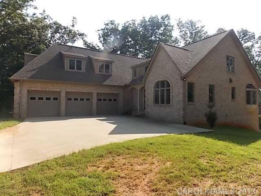 Beautiful High Rock Lake Gated Emerald Bay Community with this Gorgeous Custom Built Brick Home with Triple Attached Garage, Bonus Room, Screen Porch, Deck and Patio overlooking High Rock Lake.  Upscale Gated Lakefront Neighborhood.  Community boat ramp and storage.  Pier Permit Available for this Waterfront Lot.  Home is ready for your Custom Finishes.  Sold as Is, No Seller Repairs/concessions.