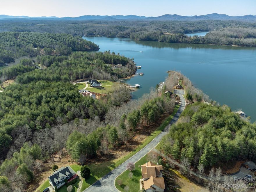 Are you searching for just the right WATERFRONT lot in a premier community on beautiful Lake James?  Then book your showing today to see this 1-acre parcel located in stunning Sunset Point! Lot 31 features a private, wooded setting with a partial clearing by the roadside to allow for your vision of the placement of your mountain lake home. With over 140 feet of water frontage tucked in a deep cove, you will enjoy access to the lake from your home site.  A winding path or stairs could easily address the moderate slope from the house to the water.  Take a quick walk or golf cart ride down to the neighborhood pavilion, boat slips, and swimming area on the point. The neighborhood also features paved, privately maintained roads; a community well system; and underground power.  Lots are rarely listed in Sunset Point, so don't miss this opportunity to see why so many are calling Lake James home!