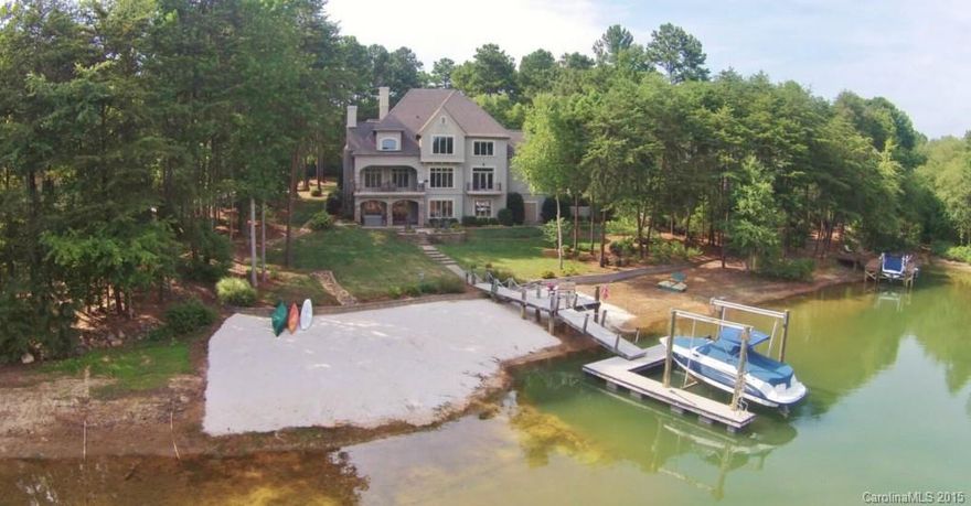 Secluded waterfront home in quiet cul-de-sac w/private deep water dock & sandy beach. This home is a rare find w/3 spectacular levels of lake living at Trump National Golf Club Charlotte. Open floor plan w/newly renovated kitchen, exotic granite throughout home w/a 2 story great room. Walkout lake level has stone fireplace, custom designed theater, summer kitchen, billiard/rec room & 5th bedroom w/full bath. All bedrooms, spacious w/beautiful views. Play on the lake right outside your back door.
