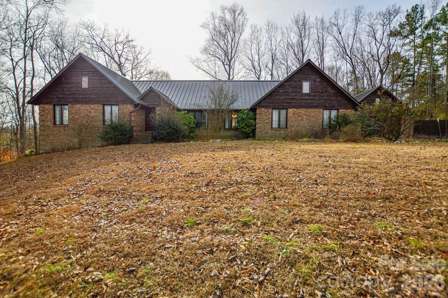 Set on approximately 16 acres along NC Highway 49 North in Mount Pleasant, this 3,200-square-foot home with a detached garage/workshop offers a rare combination of space, character, and long-term potential.

Inside, the home features original architectural details, including exposed beams, a fireplace, and a pine tongue-and-groove vaulted ceiling, creating a warm and inviting atmosphere. The layout is functional and filled with natural light, highlighted by an enclosed sunroom overlooking the pond, offering a peaceful connection to the surrounding land.

While the home reflects its original finishes and is ready for updates, it remains livable as-is, providing an opportunity for buyers to renovate and personalize while preserving its charm. The detached garage/workshop adds versatility, with ample room for storage, hobbies, or future creative use.

Conveniently located near grocery stores, Mount Pleasant schools, and major commuter routes including Highway 49 and Highway 73, the property offers easy access to town while still providing room to spread out. Whether envisioned as a private retreat, renovation project, or long-term investment, this property presents a unique opportunity in one of Cabarrus County’s most desirable communities.

Property is being sold as-is.