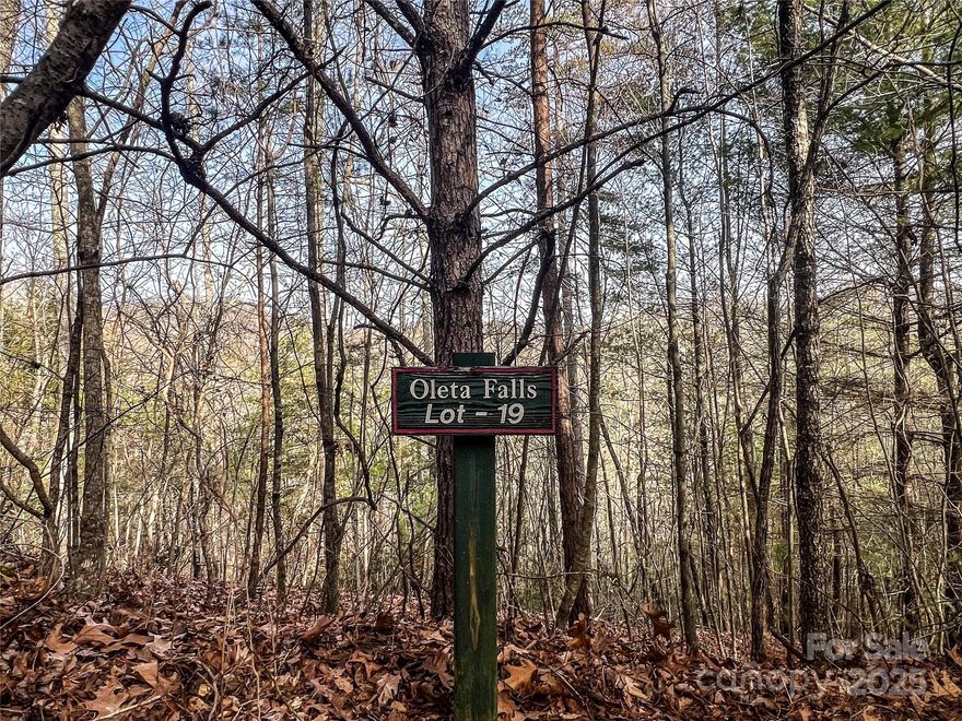 Nestled in the serene beauty of Oleta Falls, this picturesque 1+ acre lot offers the perfect setting for building your dream home. Located in a private, gated community with just 78 homesites spread across 405 acres, Oleta Falls is the epitome of luxury and tranquility.  Wake up to the sounds of nature and enjoy direct access to scenic walking trails that wind through lush forests, leading to a breathtaking 40-foot waterfall. The community is designed for both relaxation and recreation, featuring premium amenities including a clubhouse, outdoor heated pool, kiddie pool, Jacuzzi, and a well-equipped fitness center.  Whether you seek a quiet sanctuary or an active, outdoor lifestyle, Oleta Falls offers it all.