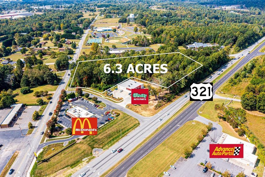 Incredible visibility along US 321-S in Granite Falls, offering 2,000 feet of road frontage on 4 sides and next to a major intersection with stoplight. NCDOT Daily Average Traffic estimate is over 30,000 vehicles/day. Can be subdivided to 1-acre parcels fronting Hwy 321 for $450,000 each. Zoned HB, for Highway Business/General Commercial development. Located adjacent to McDonald's and O'Reilly Auto Parts, this parcel is perfect location for gas station, business complex, or can be down-zoned for multi-family house development. Deed restrictions in place prevent certain restaurants from locating here, see MLS Docs for full restrictions.