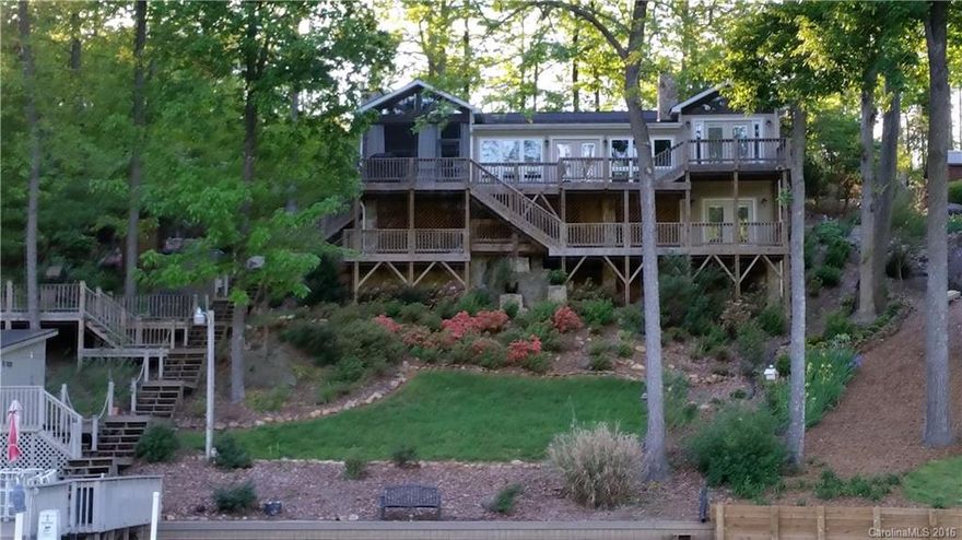 This immaculate, waterfront home is located in the quiet, restricted neighborhood of Shamrock on Badin Lake. The interior has many upgrades, including an updated kitchen, tray ceilings, & a magnificent marble bathroom with tile shower. Floating pier, with boat slip & lift, personal watercraft dock, & storage building by the lake for all your lake equipment. Upper & lower decks, covered screened porch off living room, & an additional deck near the lake. 2 fireplaces. Hot tub, & outdoor shower.