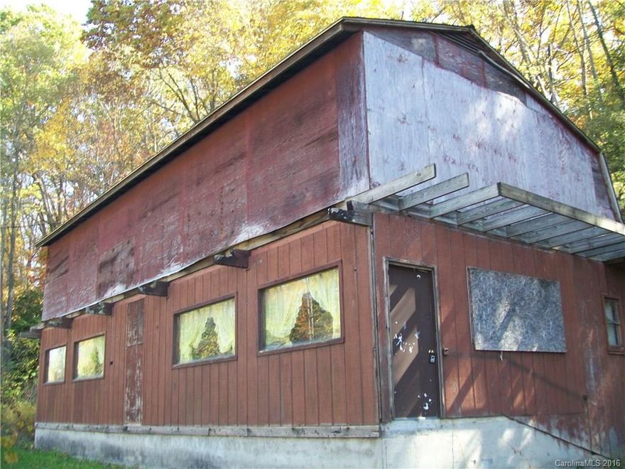 Very well known unique property. Inside shows in much better condition than outside. Has a huge second story unfinished. Could be used for a personal residence or possible lite commercial use. Priced almost $30K under tax value! Priced for a quick cash sale. Some log siding and a little tlc inside and this would be liveable quickly. Previous owner used for storage and apartment and prior to that was a restaurant. Possibly two units since upstairs is same sq footage as down stairs. Priced firm.