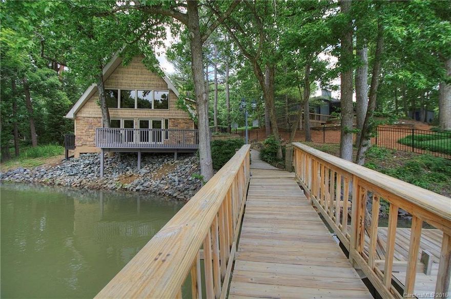 Throw a fishing line off of the deck from this delightful Lake Wylie cabin! Perfect for a weekend retreat or full-time living. Open great room/kitchen with cathedral ceiling, masonry fireplace, and beautiful views of a quiet cove. New stainless steel appliances. Two-car garage has unfinished space above if you'd like an extra bedroom, playroom, or office. Portion of yard is fenced. Great outdoor living spaces, just a few steps from the dock and boat lift. Excellent Clover schools. See tour!
