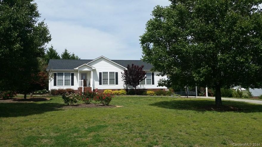 Lovely ranch home where location is a plus, immaculate inside and out, gorgeous hardwood floors, split plan for privacy, lovely bathrooms, designer kitchen, ceiling fans throughout, roof only 2 years old, new stove, new microwave, with a new addition of the 2 car carport, landscaped wonderfully with flowering trees, roses, plantings, etc., fenced yard, outbuilding & more!   Make this your home.  Better than new!!!