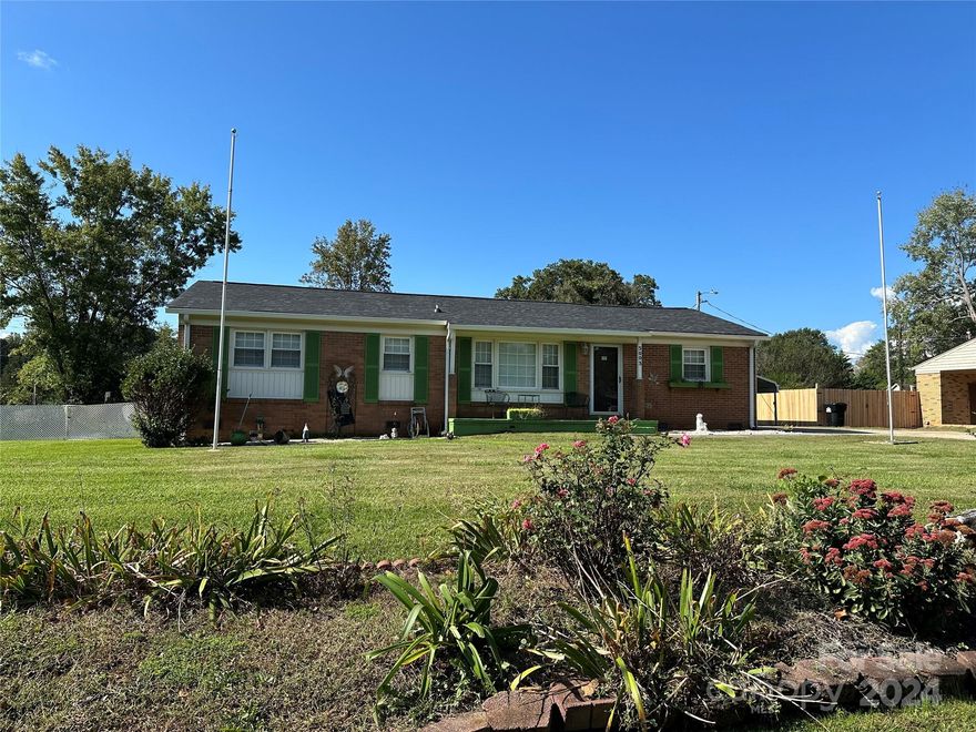 Brick Ranch on a large lot with many nice features.  New roof in September 2024.  New HVAC System installed in 2023.  This house has a large 12 x 32 screened porch with ceiling fans for entertaining or to enjoy on a nice relaxing evening.  2 Car Carport and 2 Large Storage Buildings with one being wired and ready to possibly be a workshop. There is a total of 395 sq ft included in the total HLA that offers additional living space that was added but not permitted. There is an additional room currently used as office space and another room off of a bedroom that would be ideal for possibly a nursery.  Please see the attached document regarding the septic tank system.  The sellers believe the septic tank is in the front yard but the county shows it in the rear.  There is a french  drain that was installed to help prevent any moisture in the crawlspace. Bring your buyers to see the opportunities this house presents with the extra living areas and abundance of storage.