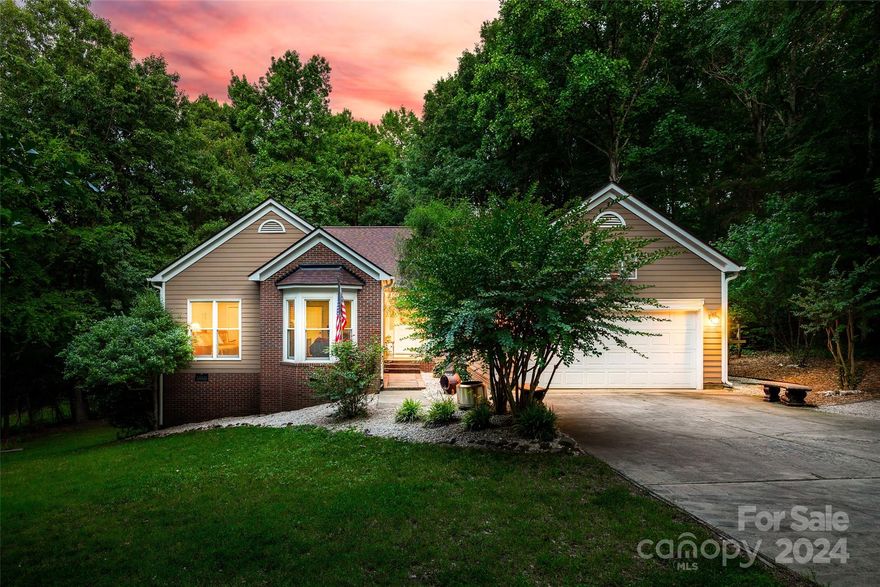 An equestrian's dream, this home sits on an acre in the desirable Black Horse Run community, complete w/ riding trails, an equestrian facility w/ arenas and stable, outdoor pool and clubhouse, & all in a tranquil SC setting w/ low taxes, just 2 miles from NC & Ballantyne! Nestled in a wooded backdrop, this ranch home greets you w/ a spacious vaulted great room & wood flooring, centered w/ a cozy gas fireplace. The kitchen boasts white cabinets, a center island, & tons of storage space! The breakfast area looks onto the covered back porch, expansive deck, & stone fire pit area. The backyard has abundant privacy, & all homes connect to the riding trails that run throughout the whole community. The primary bedroom expands into a sitting area, w/ access to the deck as well. Another 2 bedrooms & bathroom round out this ideal floor plan. Ample storage is found w/ a 2 car garage, additional gravel parking area, & storage in the walk-in crawl spaces off the back of the home. Welcome Home!